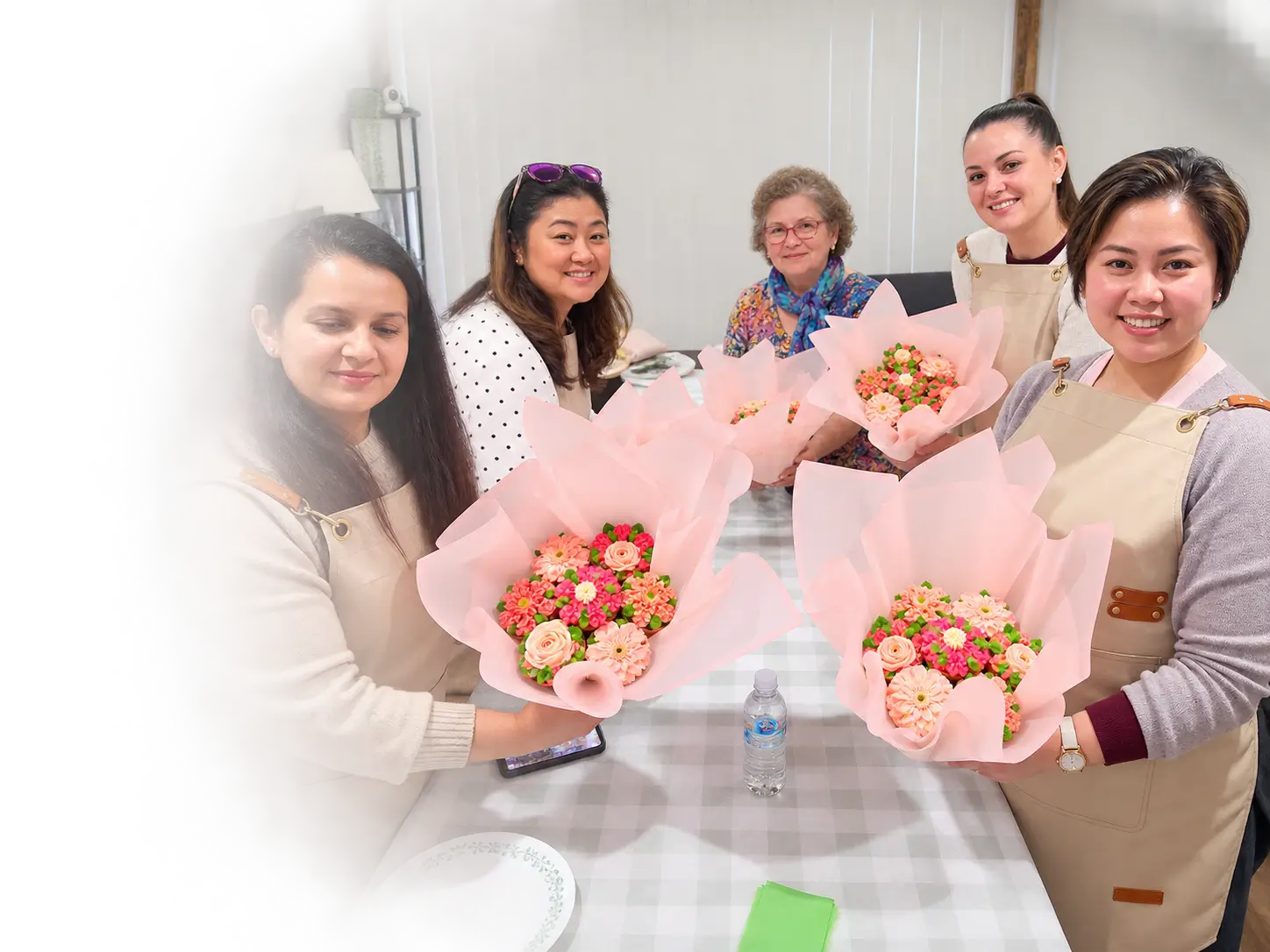 Baked Flores Box floral cupcake workshop students holding handmade cupcake bouquets